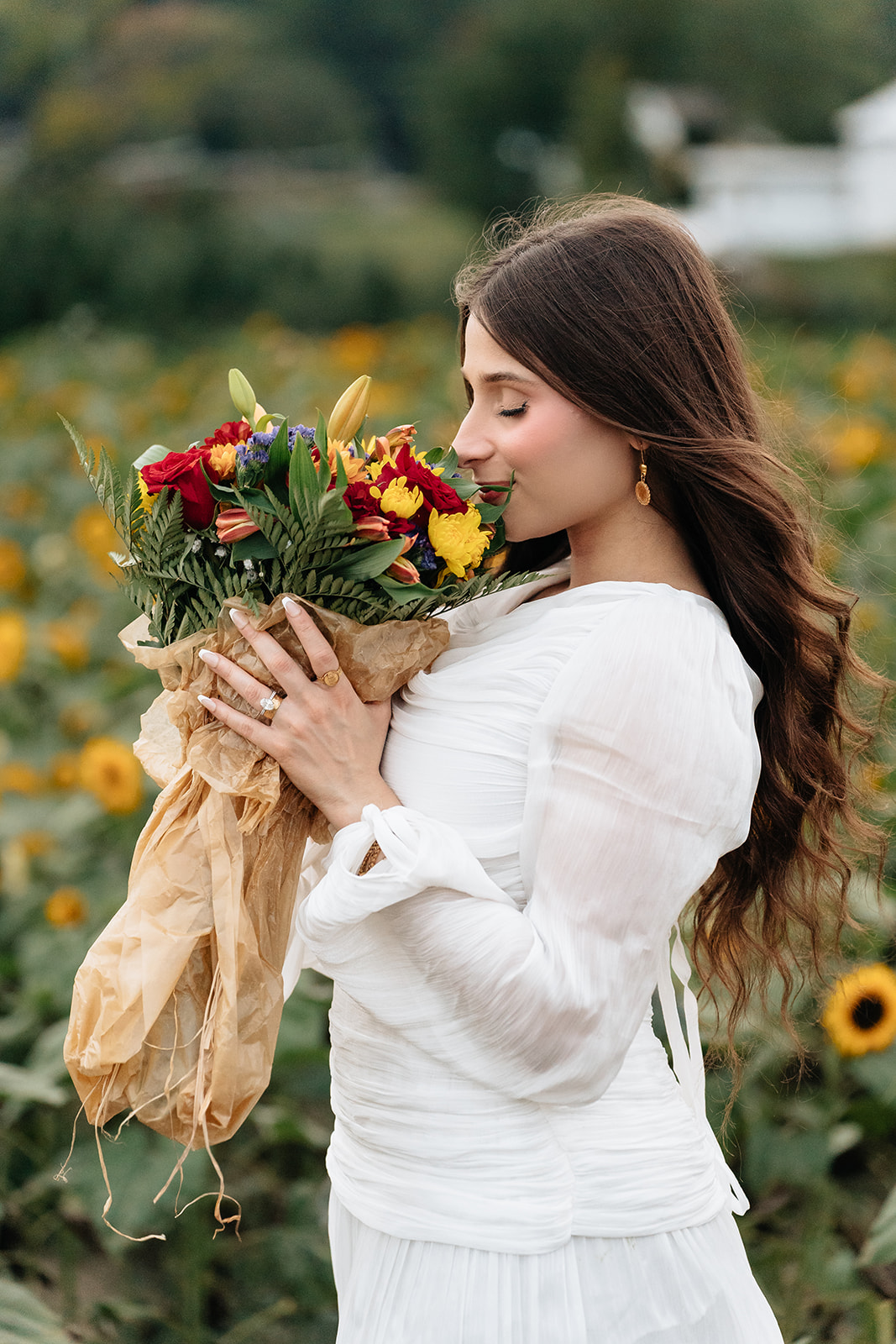 Suemaya holding a small colorful flower bouquet at the end of the Rogish Farm session