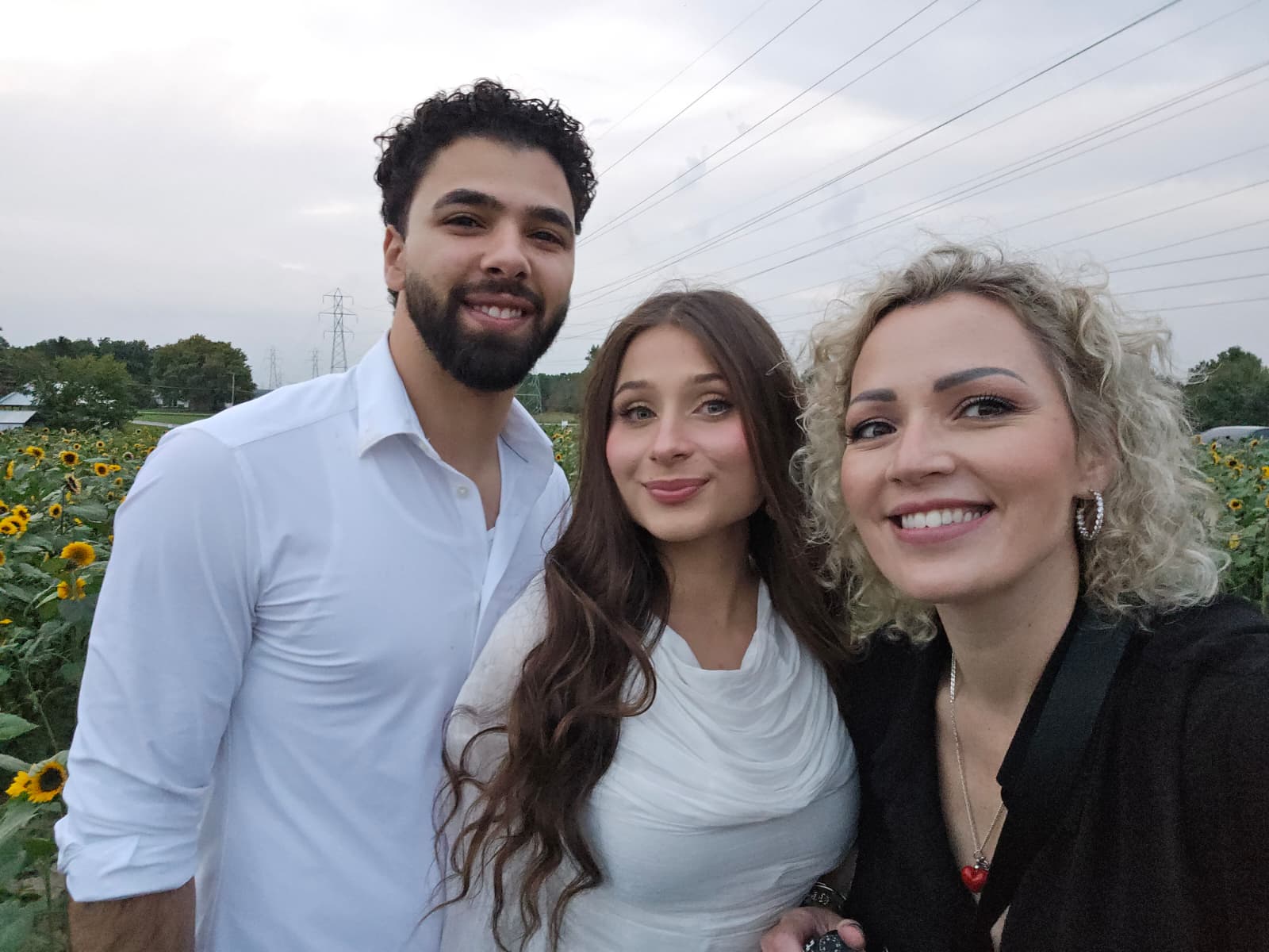 Rada Abib smiling with Suemaya and Assad after their love-story session in the sunflower fields at Rogish Farm