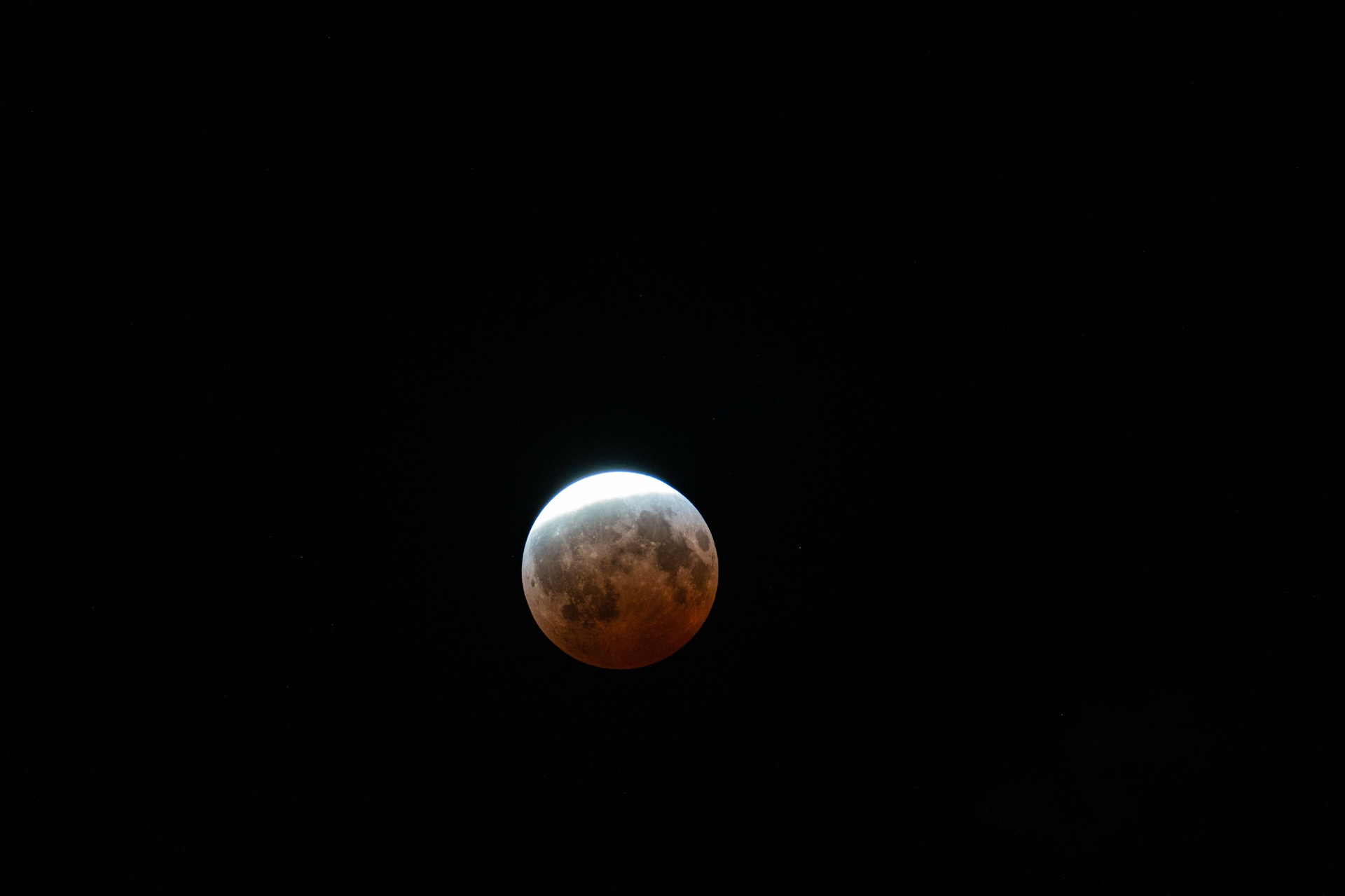 The eclipsed Moon glowing orange-red during the August 27–28, 2026 partial lunar eclipse, shot from Northeast Ohio